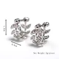 Elegant silver leaf stud earrings with crystal zirconia details on white background - Silver