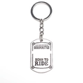 Detail of silver RIDE dog tag keychain with Born to Ride engraving on white background - Silver