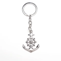 Detailed view of silver alloy nautical keychain with anchor and helm charm on white background - Silver