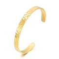 Detailed view of golden open cuff bracelet with hammered texture and polished finish - Narrow Gold