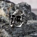 Polished stainless steel skull ring with punk gothic style on dark rock background - US Size 7 / Silver B (Chain Skull Style)