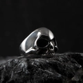Polished silver skull ring in punk gothic style on a black volcanic stone base - Silver O (Realistic High Polish)