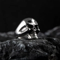 Polished silver punk skull ring for men made of vintage stainless steel on dark rock - Silver K (Gothic Realistic Skull)