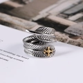Retro titanium steel feather ring with gold cross accent and intricate texture - US Size 7