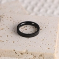 Macro view of minimalist black smooth finish ring on natural stone display - US Size 5 / Black