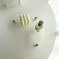 Detail of irregular water ripple acrylic tray with silver metal feet for display - Ripple Moon