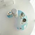 Detailed view of iridescent acrylic bean-shaped tray with metallic support legs for decor - Iridescent Moon