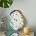 Melting art wall clock with orange-blue gradient and Roman numerals in modern living room - Rainbow