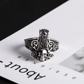 Close-up of gothic Thor’s hammer ring with skull relief and Celtic scrollwork - US Size 9