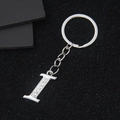 Elegant silver letter I keychain featuring sparkling rhinestones on polished metal ring - Letter I