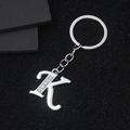 Polished silver metal letter K keychain with inlaid rhinestones on a black background - Letter K