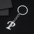 Silver letter P keychain with sparkling rhinestones on a textured black background - Letter P