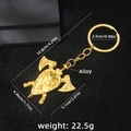 Golden Viking axe and shield keychain with Nordic rune design on black background - Gold