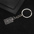 Retro lion head tarot keychain with The Strength engraving on black matte shield - The Strength Tarot Keychain