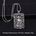 Retro silver Buddha pendant necklace with engraved relief on a textured black surface - Amitabha Buddha