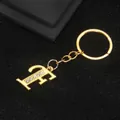 Golden keychain featuring letter F pendant with sparkling rhinestones and metal ring - Letter F Style / Gold