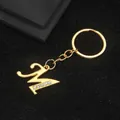 Golden alloy letter M keychain featuring five white rhinestones on a black texture - Letter M Style / Gold