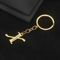 Golden alloy letter K keychain featuring sparkling white crystals on black surface - Letter X Style / Gold