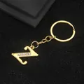 Polished gold letter Z keychain pendant with sparkling rhinestones on black background - Letter Z Style / Gold