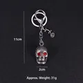 Portachiavi teschio punk con occhi di strass rossi e lucertola, lungo 11cm - Red Rhinestone Skull