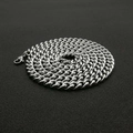 Polished silver stainless steel Cuban link necklace with lobster clasp on black background - 7mm*70cm
