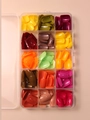 Top view of a 15-grid storage box with colorful short glossy ABS false nail tips - Rainbow
