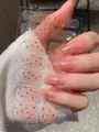 Detail showing gradient pink nail stickers with gold stars and glitter on hands - Sakura Pink Gradient Gold Star Sequins Style (PDD-231)