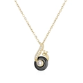 Detail of a gold snail pendant necklace featuring a black round inlay and sparkly zircon - Gold Tone Black Ceramic