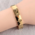 Detailed view of golden geometric square link bracelet with 3D faceted pyramid texture - Gold Style