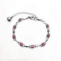 Pulsera plateada con cristales de circonita rosa y un pequeño colgante de campana - Circón Rojo
