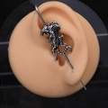 Industrial piercing bar with a vintage stainless steel tiger on a silicone ear model - Single Tiger Slant Ear Barbell