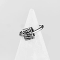 Minimalist silver stainless steel ring with gothic cross engravings on a display stand - Silver