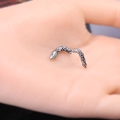 Gothic silver snake earring featuring intricate scale texture held in a hand for scale - Silver Snake