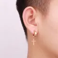 Gold stainless steel cross charm ear clips for non-pierced ears shown on a model - Clip-on Style (No Piercing) / Gold
