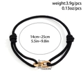 Bracciale da uomo in corda nera intrecciata con anelli dorati e chiusura regolabile - Oro(02320)