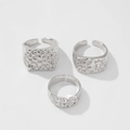 Juego de tres anillos plateados con textura de lava martillada y bandas abiertas ajustables - Plateado