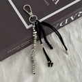 Detail of silver lobster clasp with black beaded cords and metal beads on a book - Punk Braided Rope Style (0276) / Silver