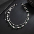 Multi-layer silver pant chain with pearls, green gems and a rhinestone cross pendant - Silver