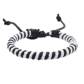 Detail of hand-woven black and white wax cord bracelet with adjustable pull-string knot - Black + Bleached White