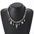 Collier bohème avec crâne de taureau, perles turquoise et cordon tressé marron - Style Tête de Taureau Chapeau de Cowboy