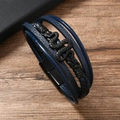 Macro detail of multi-layer leather bracelet featuring a black snake-shaped metal charm - Navy Blue