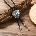 Detail of western bolo tie with heart-shaped turquoise stone and braided leather cord - Black