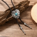 Detail of heart-shaped turquoise pendant and braided leather cord on rustic wood - Brown