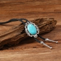 Detailed view of Western bolo tie featuring turquoise stone on rustic wood background - Oval Lace Style (RH668-3)