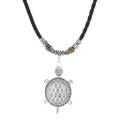 Macro detail of retro silver sea turtle pendant with intricate hexagonal shell patterns - Turtle