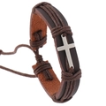 Close-up of woven leather bracelet featuring a silver cross charm and adjustable cords - Brown Cross