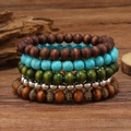 Detail of 5-piece multilayer turquoise and wood bead bracelet set on vintage wood - Retro Bronze Spacer Beads Style