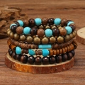 Close-up of multilayer turquoise and wooden beaded bracelets set on a rustic wood slice - Turquoise Irregular Brass Style