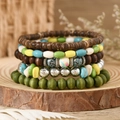 Detail of bohemian layered beaded bracelets with turquoise and wood beads on wood base - Bright Silver Metal Bead Style (5)