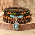 Detail of bohemian layered beaded bracelet with turquoise stones and vintage silver pendant - Cowboy Hat Pendant Style (7)